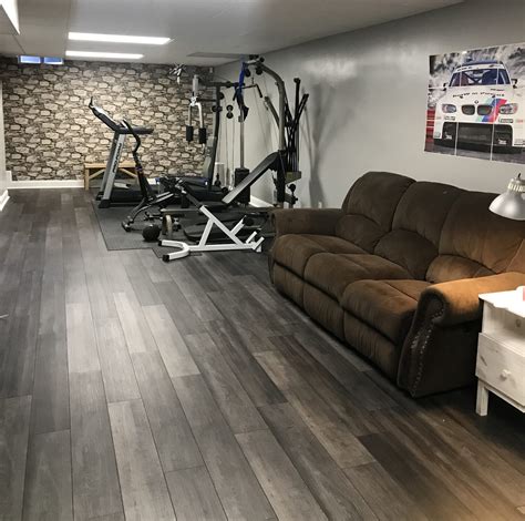Flooring for home gym - Some of the most reviewed products in Rubber Gym Flooring are the TrafficMaster Black with Blue Flecks 18 in. x 18 in. x 0.3 in. Rubber Gym Floor Tiles (6 Tiles/Pack) (14.32 sq. ft.) with 428 reviews, and the TrafficMaster Gray Raised Coin 18 in. x 18 in. x 3.1 mm Rubber Interlocking Modular Flooring Tiles, 6-Pack (13.5 sq. ft.) with 282 reviews.